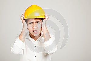 Asian Engineer girl with hard hat got headache