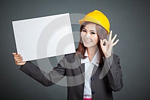 Asian engineer girl ok with a blank sign