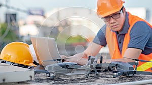 Asian engineer man using drone and laptop for construction site