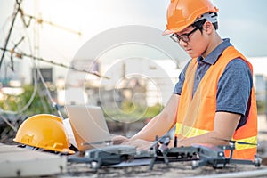 Asian engineer man using drone and laptop for construction site