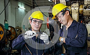 Asian engineer Safety uniforms use vernier calipers to measure workpieces