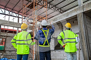 Asian engineer technician team inspector of workers to productivity build a house in the construction site