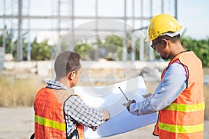 Asian engineer using radio to command to labour team in site construction