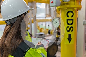 Asian engineer wearing glasses working in the boiler room