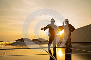 Asian engineers and technician on roof checking solar cell panel use laptop and radio communication, Solar power, Clean energy,