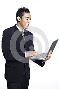 Asian entrepreneur looking at laptop computer