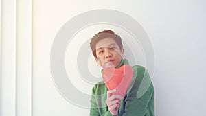 Asian ethnic LGBT tomboy holding heart shape balloon looking for good date and relationship
