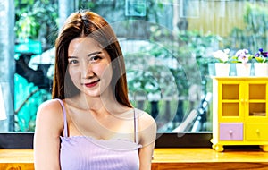 Asian face ,Portrait young Asian pretty woman smiling in cafe, She looking at the camera