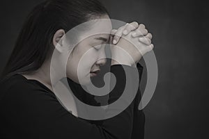 Asian face woman praying and worship to GOD Using hands to pray in religious beliefs and worship christian in the church or in gen