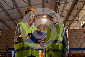 Asian factory manager and engineer woman working in warehouse