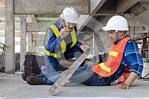 Asian factory worker having accident while working in manufacturing site while his colleague is helping for safety workplace and