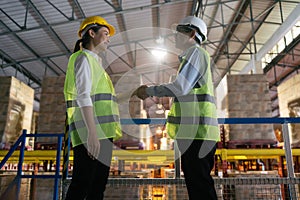 Asian factory worker team hands shaking greeting on site and warehouse factory.