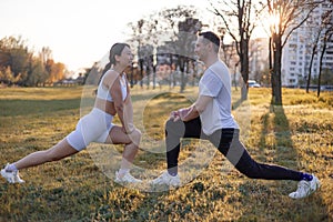 Asian famale and caucasian male couple Exercise in the outdoor park in the morning. They are healthy, smiling and happy.