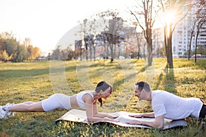 Asian famale and caucasian male couple Exercise in the outdoor park in the morning. They are healthy, smiling and happy