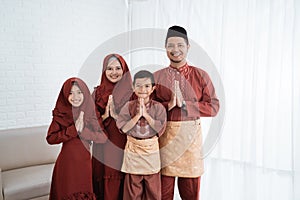 Asian families smile with gestures of apologize when wish Happy Ramadan Kareem