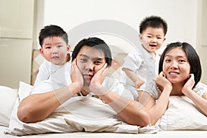 Asian family on bed