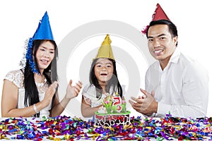 Asian family celebrating a birthday on studio