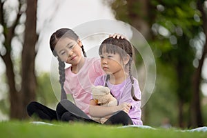 Asian family children elder sister comforts her younger sister