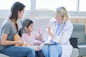 Asian family consult with doctor at hospital