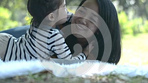 Asian family Daughter and mother enjoy relax in summer park, spending time together