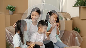 Asian Family Eating Pizza Packing Boxes Moving New House Indoor