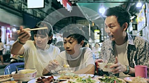 Asian family eating in Street food Night market for tourist on chinatown at yaowarat road in Bangkok