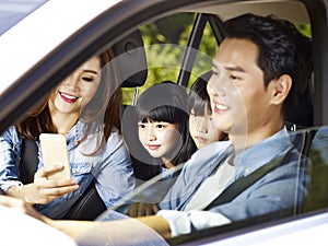 Asian family enjoying a car ride