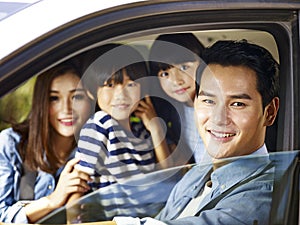 Asian family enjoying a car ride