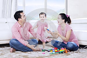 Asian family enjoying leisure time with toys