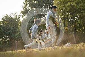 Asian family enjoying outdoor activity in city park