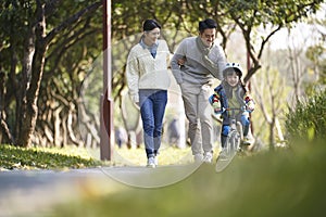 Asian family enjoying outdoor activity in city park