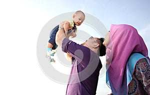 Asian family enjoying quality time on the beach