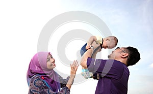 Asian family enjoying quality time on the beach