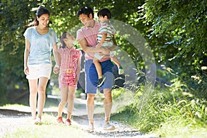 Asian Family Enjoying Walk In Countryside