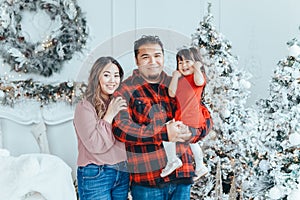 Asian family father dad hugging with daughter toddler girl celebrating Christmas or New Year. Mixed race dad man with kid standing