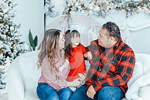 Asian family father, mother with daughter toddler girl celebrating Christmas or New Year at home