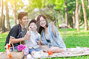 Asian family happiness play fun holiday together outdoor park background