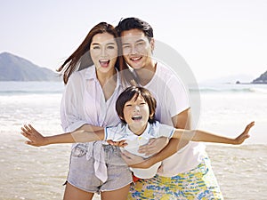 Asian family having fun on beach