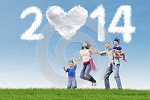 Asian family having fun under cloud of new year 2014