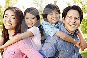 Asian family head and shoulders portrait outdoors