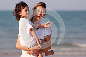 Asian family play sand on beach