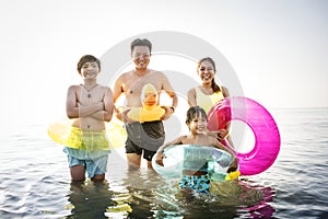 Asian family playing at the beach