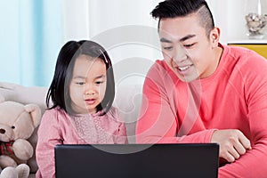 Asian family playing on computer