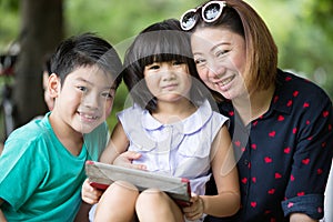 Asian family are playing together with a computer tablet in the