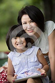 Asian family are playing together with a computer tablet in the