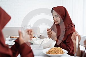 Asian family pray when breaking fast