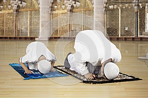 Asian family praying in the mosque