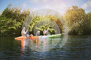 asian family sailing kayak boat in fresh water lagoon ,kayaking is one of most popular activity in thailand