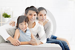 Asian family on sofa in living room
