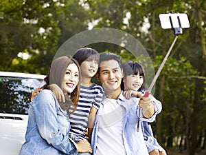 Asian family taking a selfie during trip
